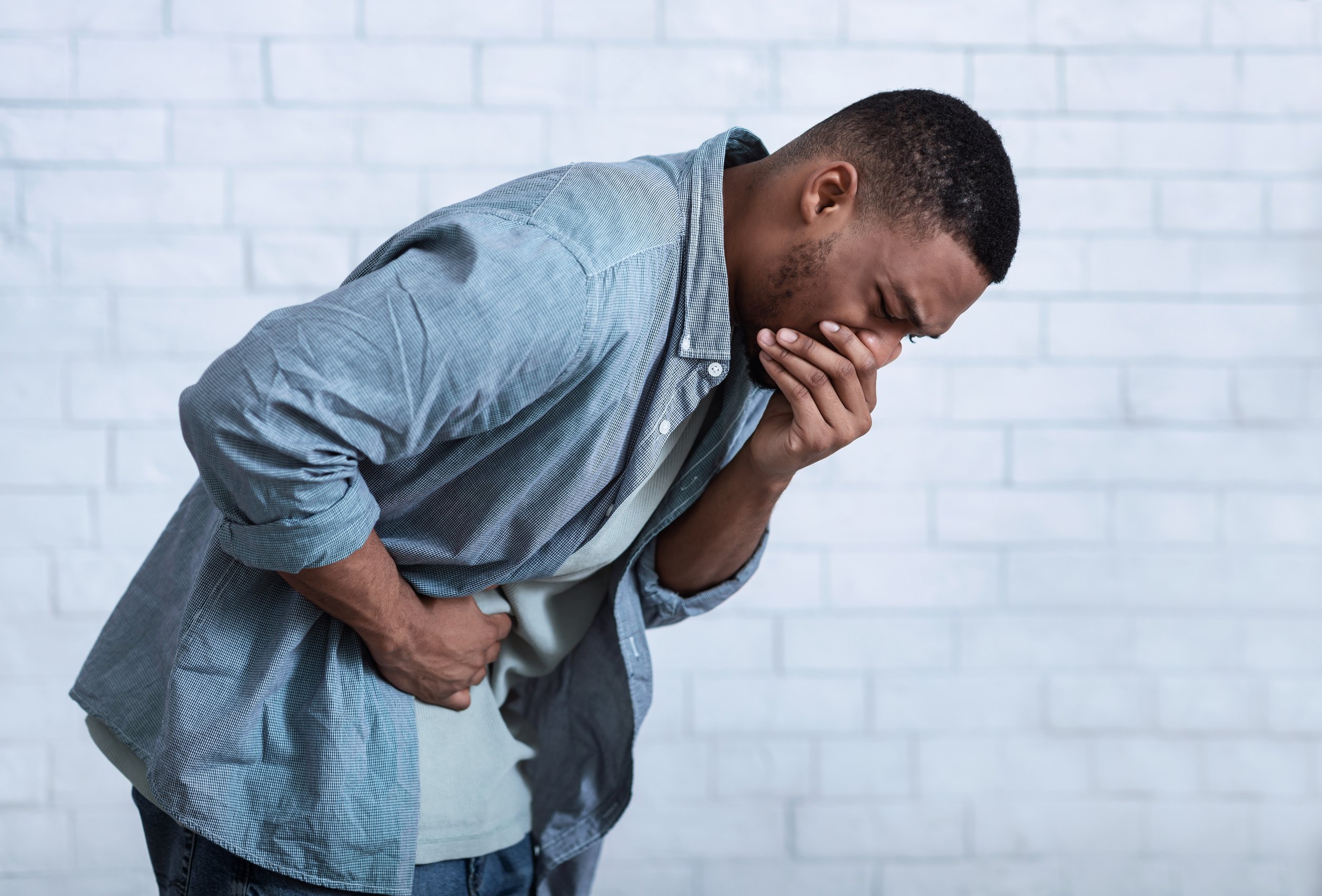 African Man Vomiting Having Nausea And Stomachache, Gray Background, Side-View